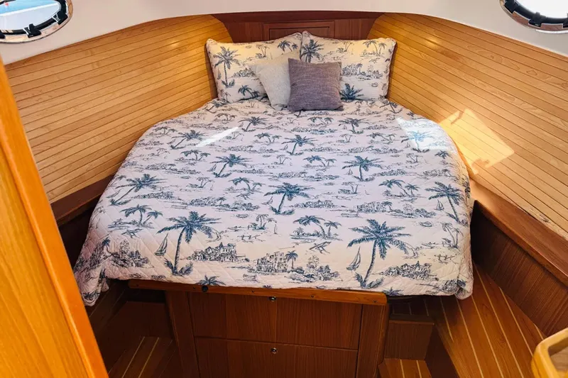 Forever Moor Yacht Photos Pics Cozy cabin interior of 2024 True North 34 Outboard Express with nautical-themed bedding.