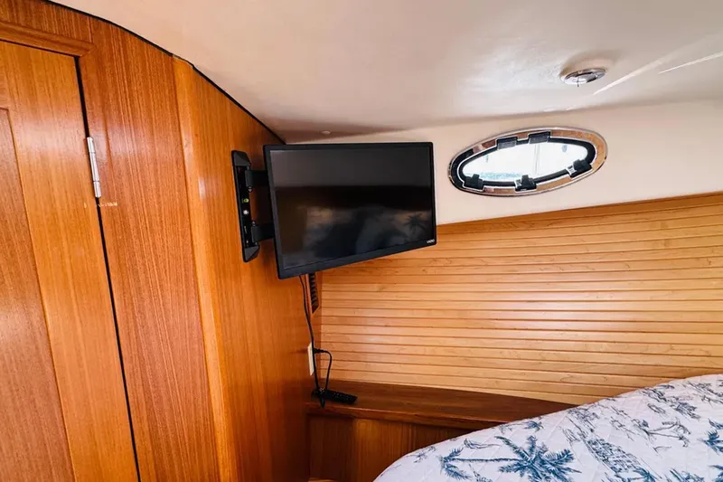 Forever Moor Yacht Photos Pics 2024 True North 34 Outboard Express cabin with TV and wooden interior.