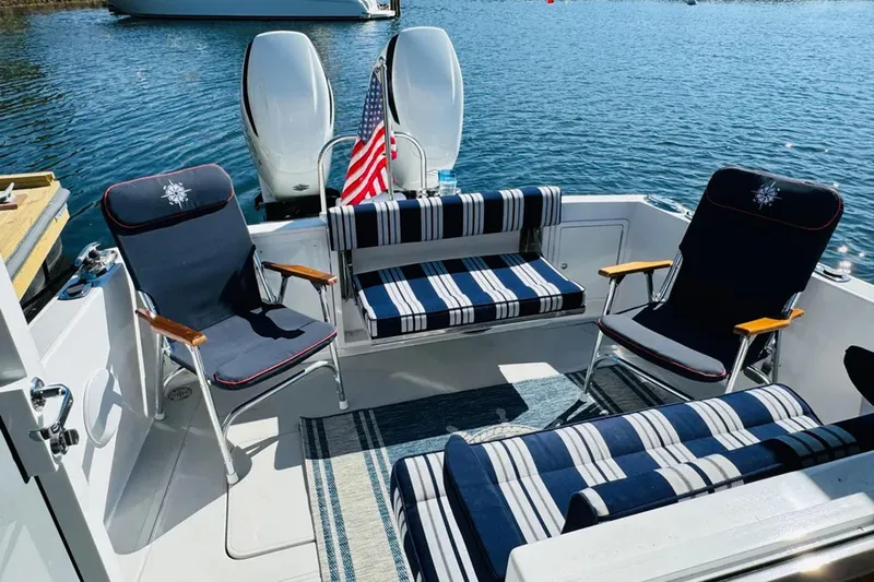 Forever Moor Yacht Photos Pics 2024 True North 34 Outboard Express boat with striped seating and American flag.