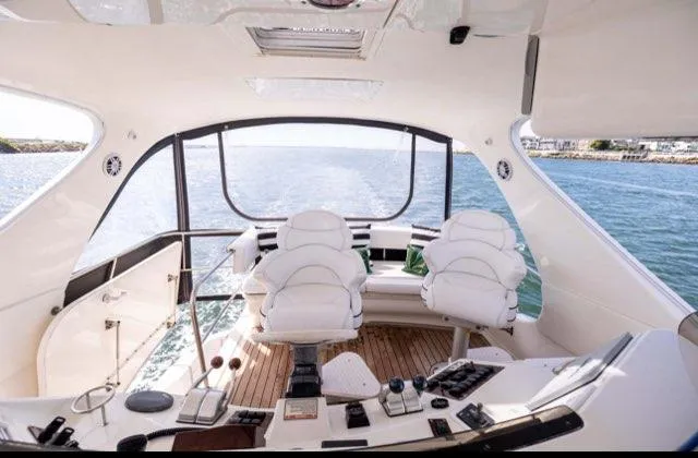  Yacht Photos Pics Luxurious 2002 Sea Ray 560 Sedan Bridge yacht interior with white seating and ocean view.