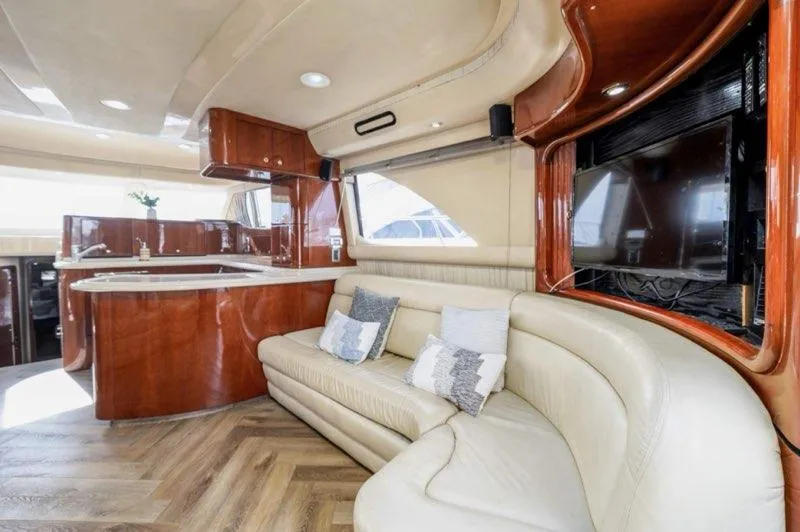  Yacht Photos Pics Luxurious interior of 2002 Sea Ray 560 Sedan Bridge yacht with leather seating and wood finishes.