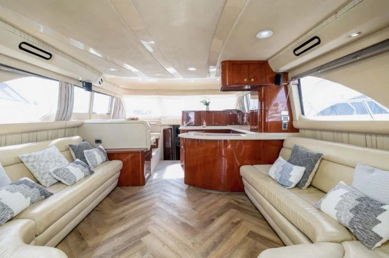  Yacht Photos Pics Luxurious interior of 2002 Sea Ray 560 Sedan Bridge yacht with elegant seating and wood finishes.