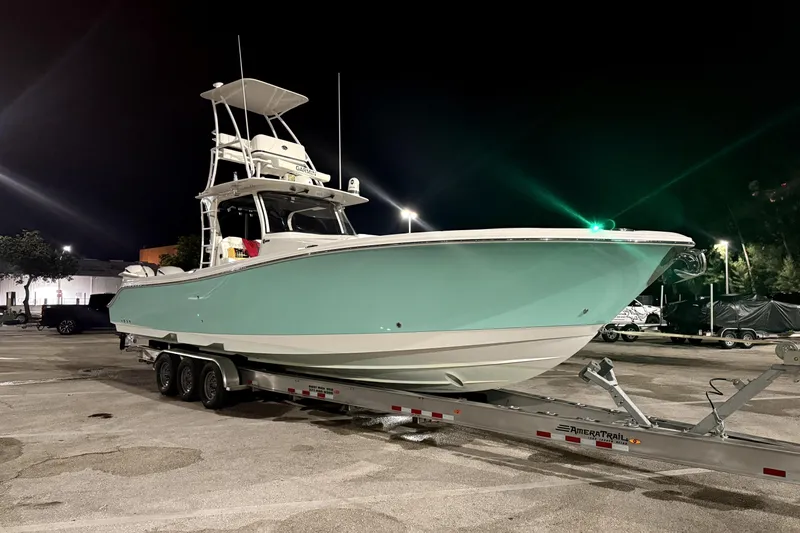  Yacht Photos Pics 2018 Edgewater 370CC boat on trailer at night, illuminated by streetlights.