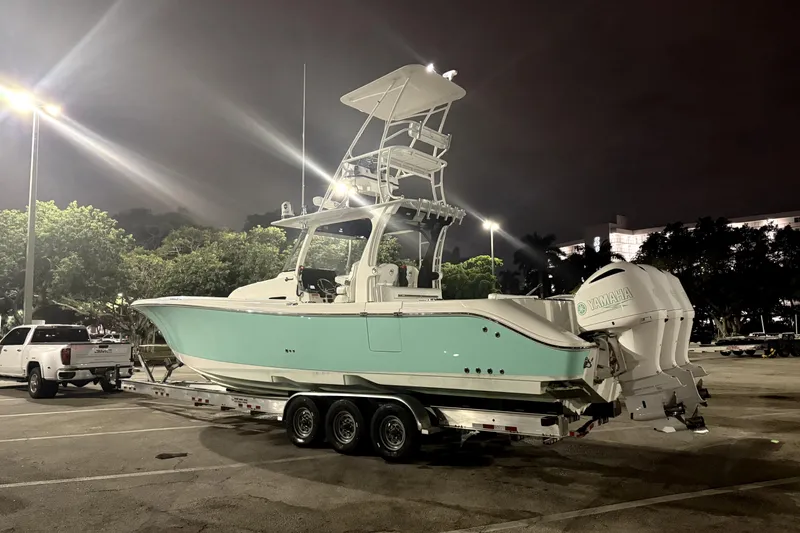  Yacht Photos Pics 2018 Edgewater 370CC boat on trailer, parked at night with Yamaha engines.