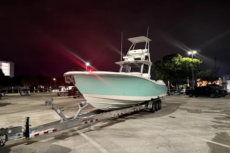  Yacht Photos Pics 2018 Edgewater 370CC boat on trailer in parking lot at night.