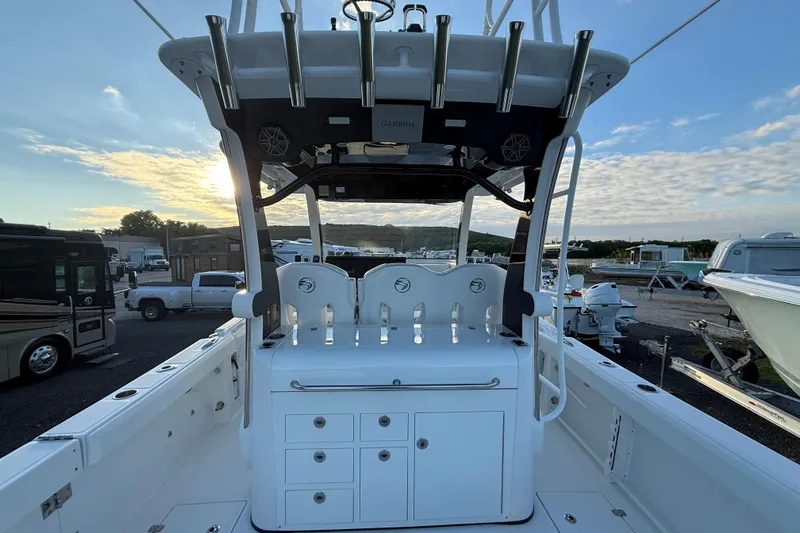  Yacht Photos Pics 2018 Edgewater 370CC boat interior with fishing rod holders and storage, parked at marina.