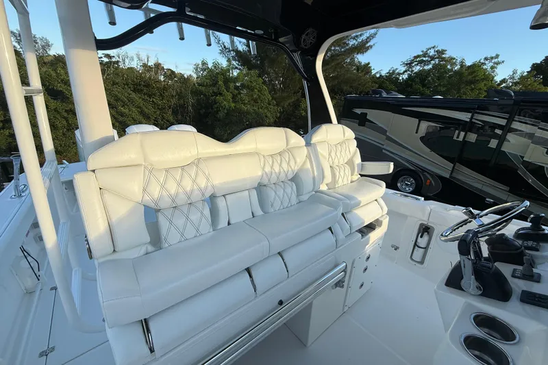  Yacht Photos Pics Luxurious white seating on 2018 Edgewater 370CC boat, featuring modern helm and controls.