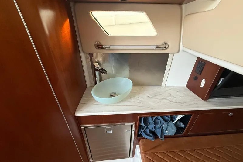  Yacht Photos Pics Luxurious interior of 2018 Edgewater 370CC boat featuring modern sink and cabinetry.