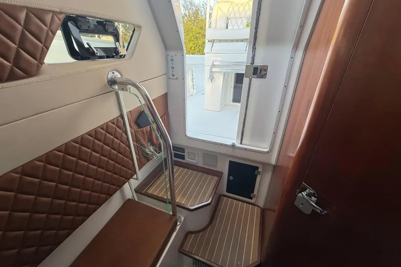  Yacht Photos Pics Interior of a 2018 Edgewater 370CC boat with elegant seating and wood accents.