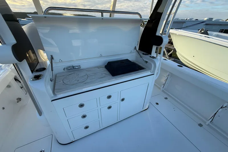  Yacht Photos Pics 2018 Edgewater 370CC boat interior with a sleek kitchenette and storage drawers.