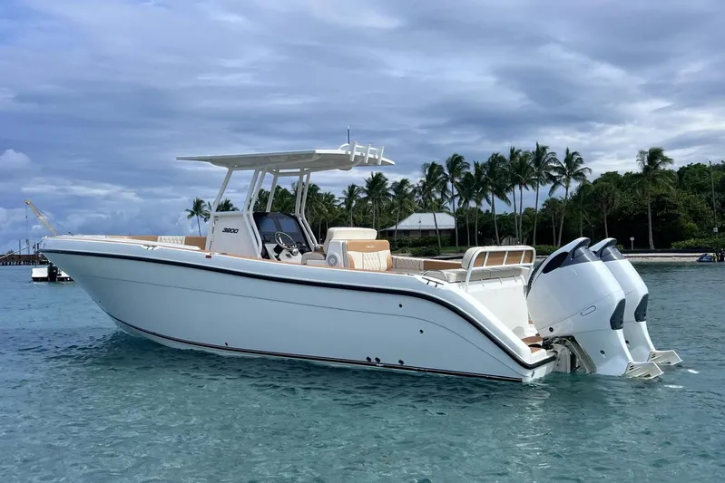  Yacht Photos Pics 2019 Century 3200 Center Console boat on clear water with palm trees in background.