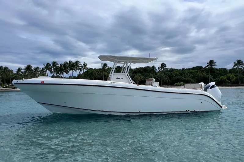  Yacht Photos Pics 2019 Century 3200 Center Console boat on clear tropical waters with palm trees in background.