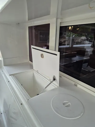 Chapter Two Yacht Photos Pics Lagoon 450 yacht interior, 2014 model, featuring open storage compartment and sleek design.