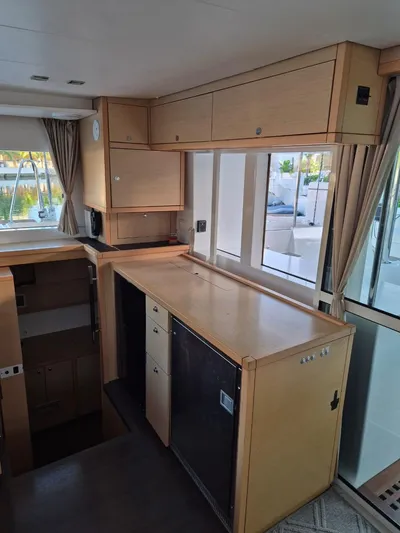 Chapter Two Yacht Photos Pics Interior of 2014 Lagoon 450 catamaran with modern cabinetry and large windows.
