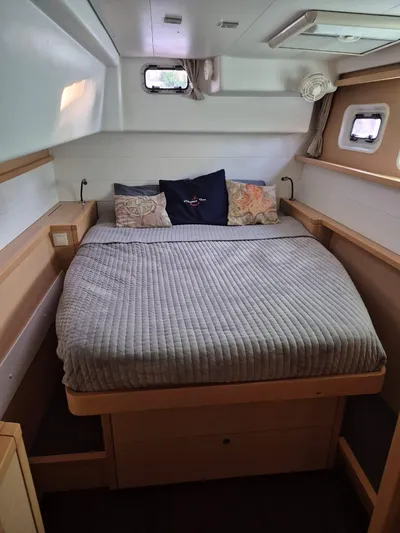 Chapter Two Yacht Photos Pics Cozy cabin interior of 2014 Lagoon 450 catamaran with comfortable bedding and natural light.
