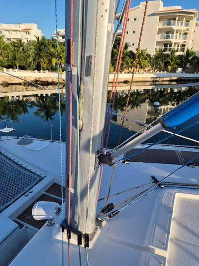 Chapter Two Yacht Photos Pics Lagoon 450 catamaran deck with mast and rigging, docked near waterfront buildings, 2014 model.
