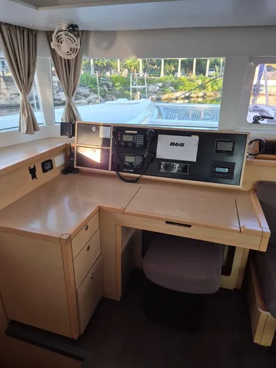 Chapter Two Yacht Photos Pics Interior view of 2014 Lagoon 450 yacht's navigation station with control panel and seating.