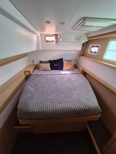 Chapter Two Yacht Photos Pics Cozy cabin interior of 2014 Lagoon 450 catamaran with comfortable bed and porthole windows.