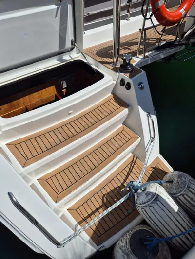 Chapter Two Yacht Photos Pics Stern view of 2014 Lagoon 450 catamaran with wooden steps and docked fenders.