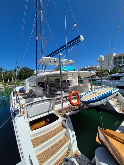 Chapter Two Yacht Photos Pics 2014 Lagoon 450 catamaran docked, featuring spacious deck and modern amenities under clear blue sky.