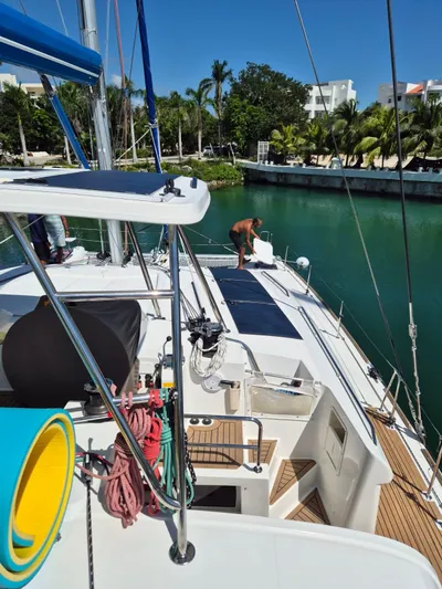 Chapter Two Yacht Photos Pics 2014 Lagoon 450 catamaran docked in a tropical marina with lush greenery.