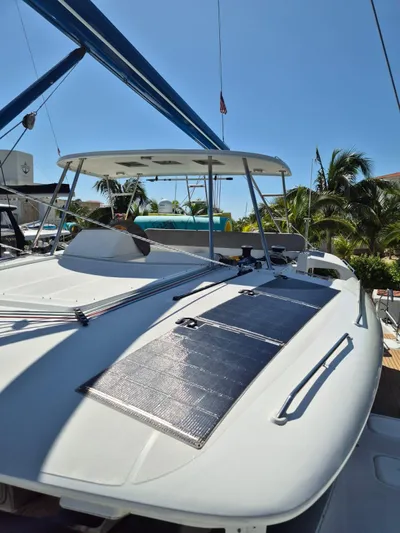 Chapter Two Yacht Photos Pics 2014 Lagoon 450 catamaran with solar panels, docked under clear blue sky.