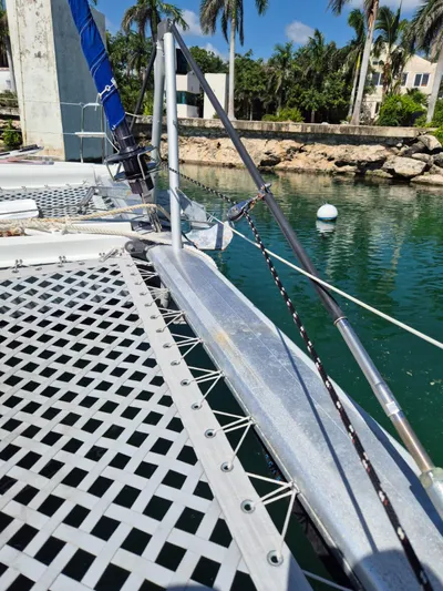 Chapter Two Yacht Photos Pics Lagoon 450 catamaran deck, 2014 model, docked near tropical shoreline.