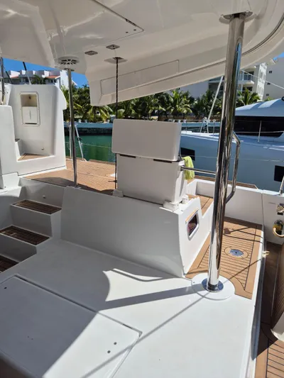 Chapter Two Yacht Photos Pics 2014 Lagoon 450 yacht deck with seating, polished railings, and wooden flooring.