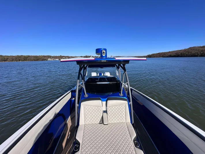  Yacht Photos Pics 2015 Nor-Tech 340 Sport Center Console on calm water, showcasing sleek design and spacious seating.