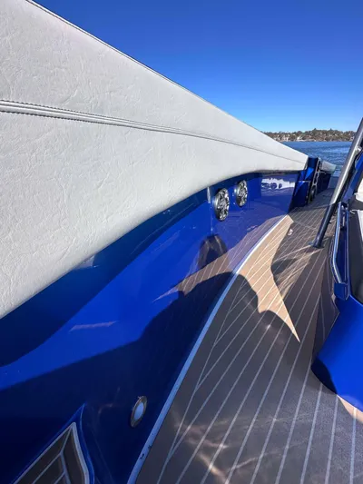  Yacht Photos Pics 2015 Nor-Tech 340 Sport Center Console, sleek blue exterior, wooden deck, clear sky background.