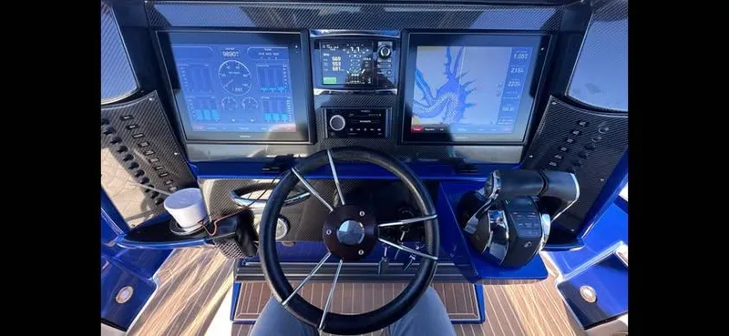  Yacht Photos Pics 2015 Nor-Tech 340 Sport Center Console dashboard with navigation screens and steering wheel.