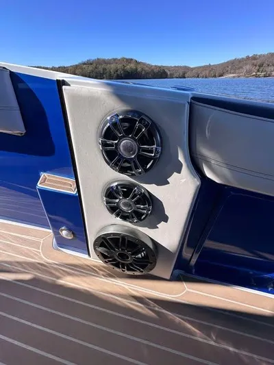  Yacht Photos Pics 2015 Nor-Tech 340 Sport Center Console boat speakers on deck, with scenic lake view.