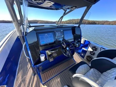  Yacht Photos Pics 2015 Nor-Tech 340 Sport Center Console boat dashboard with dual screens on a lake.