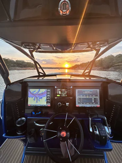  Yacht Photos Pics 2015 Nor-Tech 340 Sport Center Console dashboard at sunset on the water.