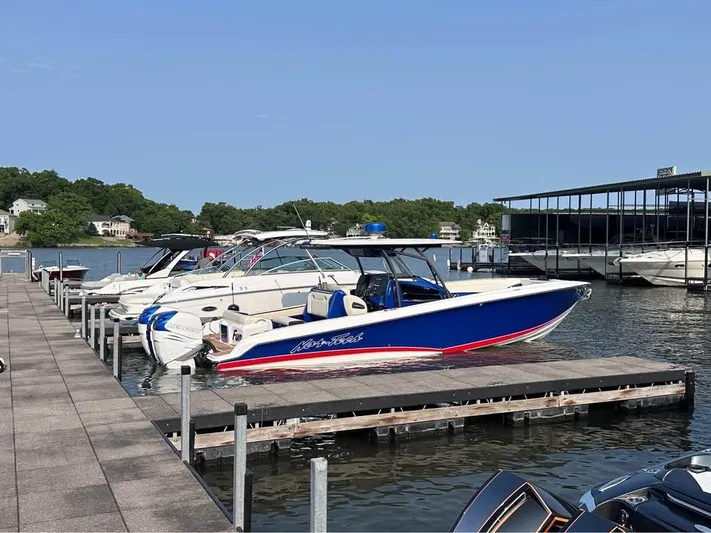  Yacht Photos Pics 2015 Nor-Tech 340 Sport Center Console boat docked at a marina.