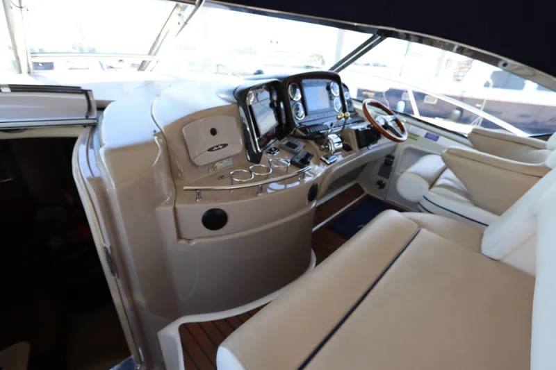 Yacht Photos Pics Helm of 2004 Sea Ray 420 Sundancer with beige seating and modern controls.
