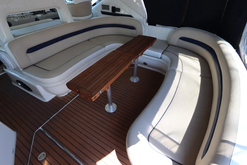  Yacht Photos Pics Luxurious seating area on 2004 Sea Ray 420 Sundancer yacht with wooden table and cushioned benches.