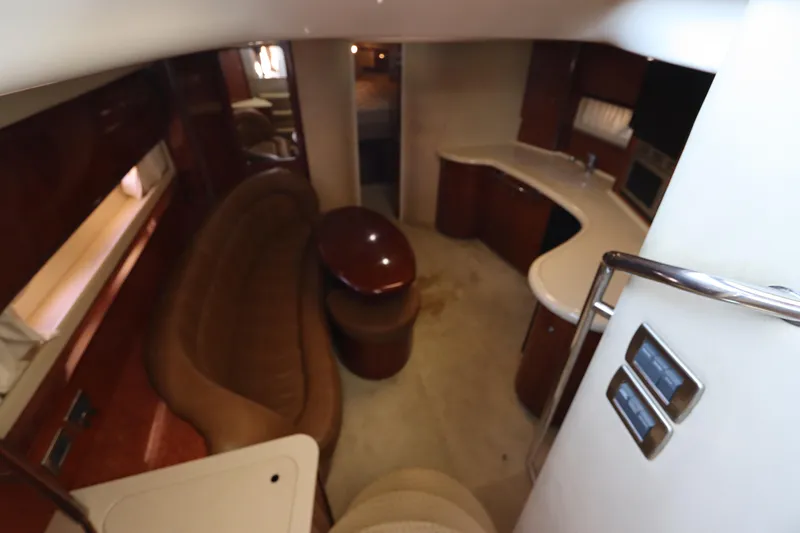  Yacht Photos Pics 2004 Sea Ray 420 Sundancer interior with curved seating and kitchenette.