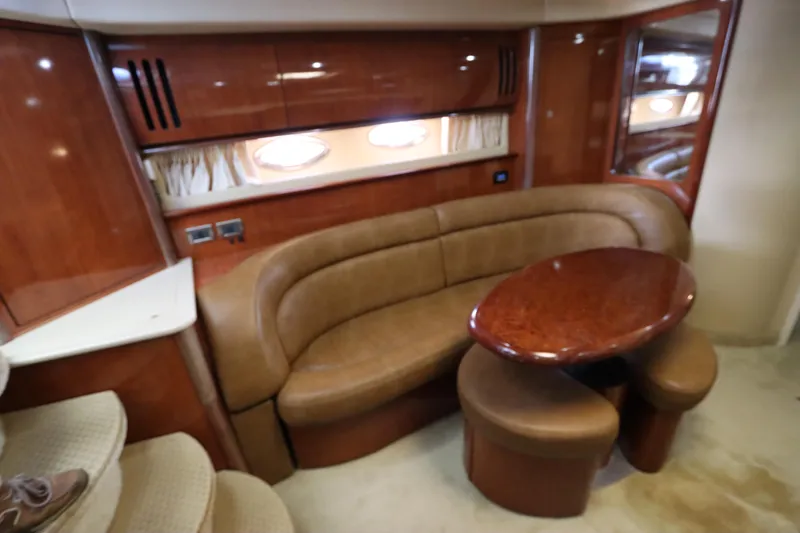  Yacht Photos Pics Luxurious interior of 2004 Sea Ray 420 Sundancer with leather seating and wooden table.
