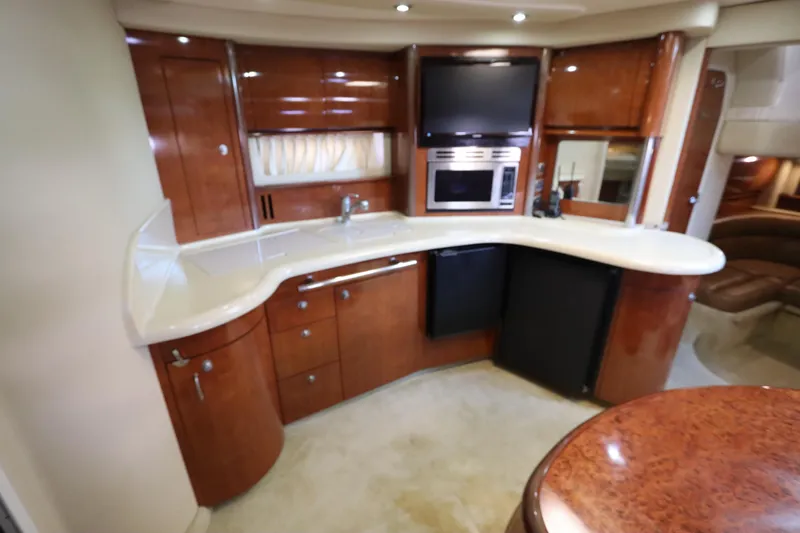  Yacht Photos Pics Luxurious 2004 Sea Ray 420 Sundancer yacht interior kitchen with wood cabinetry and modern appliances.