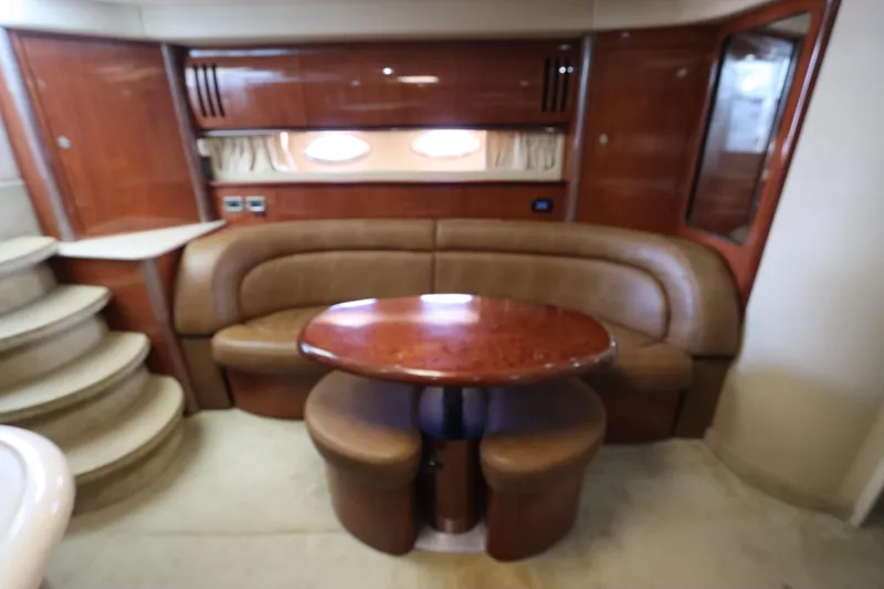  Yacht Photos Pics Luxurious interior of 2004 Sea Ray 420 Sundancer yacht with leather seating and wooden table.