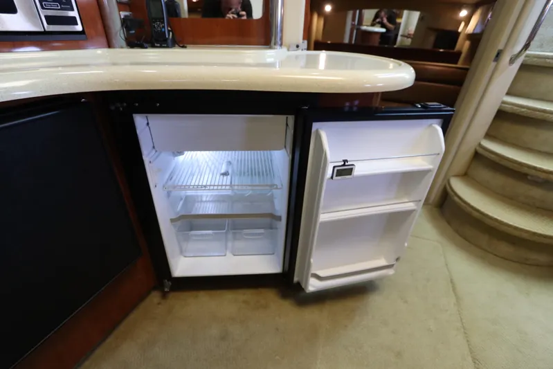  Yacht Photos Pics Open refrigerator in 2004 Sea Ray 420 Sundancer yacht interior, near curved staircase.