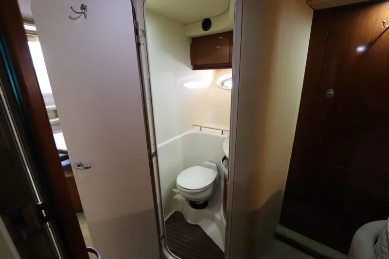  Yacht Photos Pics 2004 Sea Ray 420 Sundancer yacht bathroom interior with toilet and wooden accents.