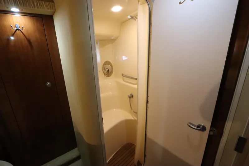  Yacht Photos Pics Shower area inside 2004 Sea Ray 420 Sundancer yacht, featuring wooden accents and modern fixtures.