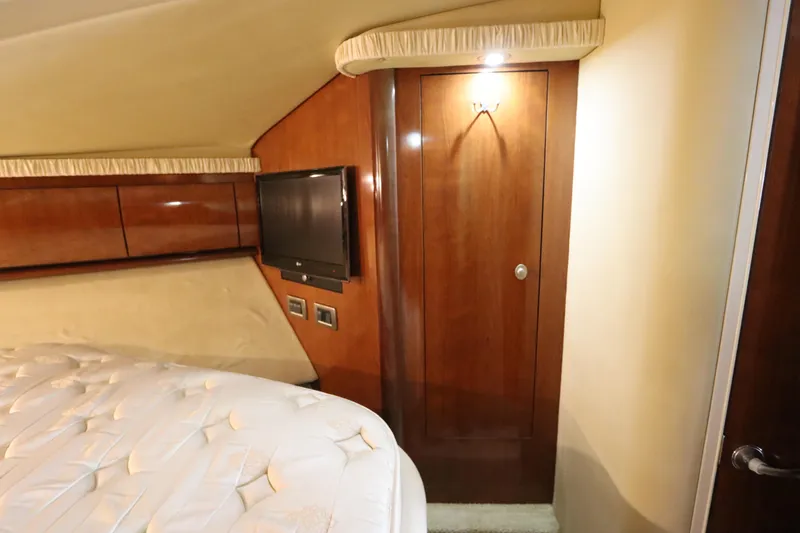  Yacht Photos Pics Interior of 2004 Sea Ray 420 Sundancer with wood paneling, TV, and bed.