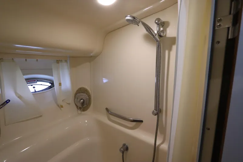  Yacht Photos Pics Shower area in 2004 Sea Ray 420 Sundancer yacht, featuring handheld showerhead and porthole window.