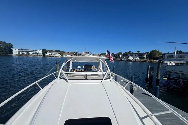  Yacht Photos Pics 2012 Intrepid 390 Sport Yacht docked at marina, clear blue sky, American flag displayed.