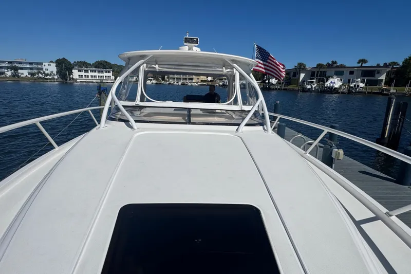  Yacht Photos Pics 2012 Intrepid 390 Sport Yacht docked, featuring sleek design and American flag.