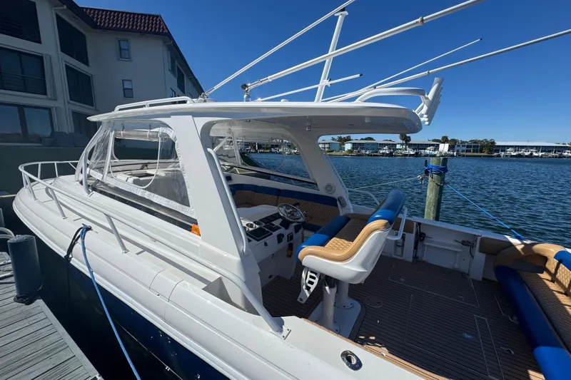  Yacht Photos Pics 2012 Intrepid 390 Sport Yacht docked by waterfront, featuring sleek design and spacious seating.