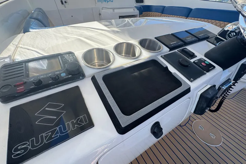  Yacht Photos Pics Control panel of a 2012 Intrepid 390 Sport Yacht with Suzuki branding and navigation equipment.